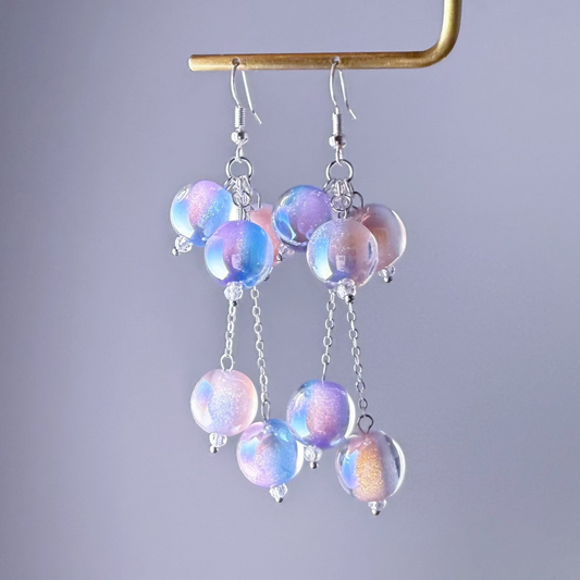 Multicolored beaded earrings on a gray background